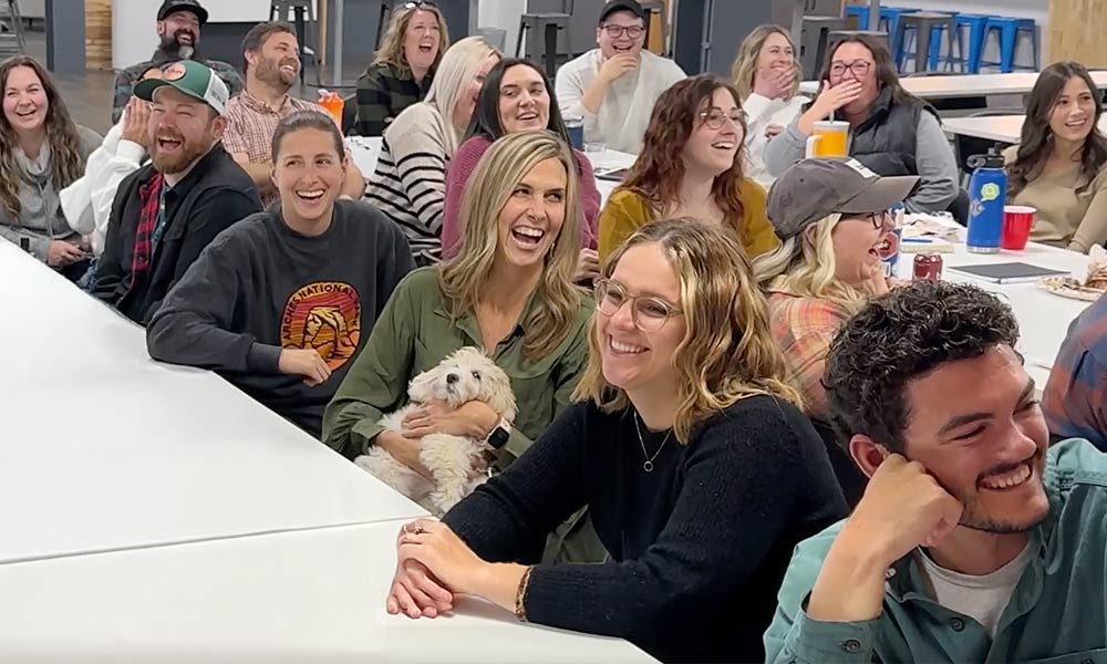 team laughing and celebrating together